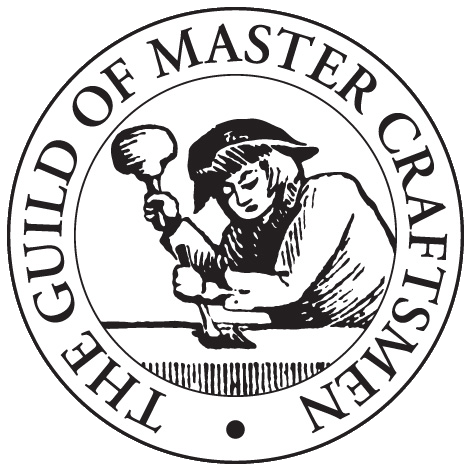Emblem of the Guild of Master Craftsmen featuring a craftsman at work with tools.